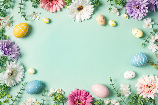 Happy Easter composition for easter design. Elegant Easter eggs and spring flowers on mint background. Flat lay, top view, copy space.