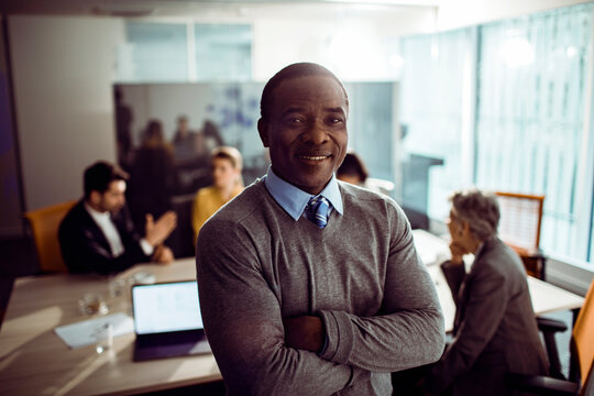 Portrait of a mature successful black businessman in busy office
