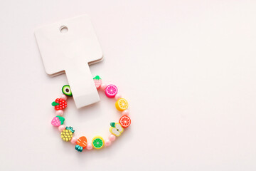 Colorful bracelet with tag and fruit-shaped beads