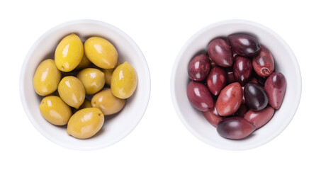 Green and Kalamata olives with pit, pickled whole, large Greek table olives, in white bowls. Green olives picked when still unripe, and Kalamata olives picked when ripe, both preserved in a brine.