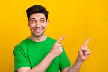 Photo of young happy man in green t shirt direct fingers empty space introduce new netflix series...