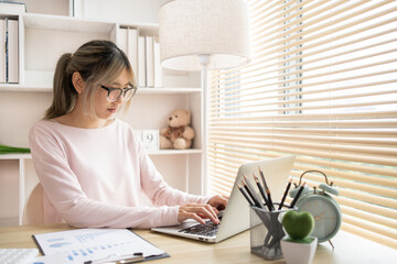 Young woman uses a computer to work, Work from the comfort of home, Work from home.