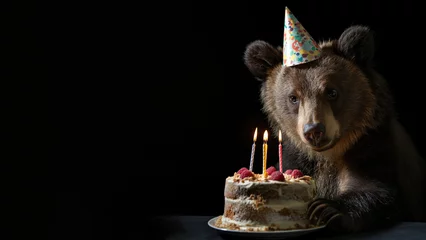 Poster Im Rahmen Photo of bear having birthday party isolated on black background © d-AI-n