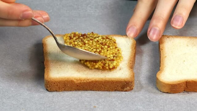 Preparing process of Croque monsieur and croque madame, grilled sandwiches with dijon mustard.