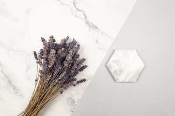 Top view of lavender flowers on grey and white marble background. Lavender bouquet, marble tray flat lay. Copy space.