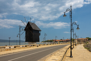 Fototapeta na wymiar Old windmill at the entrance to the Old Town of Nessebar, ancient city on the Black Sea coast of Bulgaria.