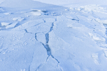 Fototapeta na wymiar Ice hummocks covered with snow. Broken ice fragments