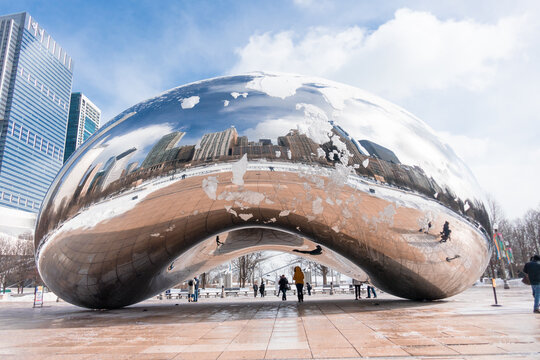 Chicago, Illinois - USA: Cloud Gate in Millennium Park on a frigid, sunny winter day with snow and reflections
