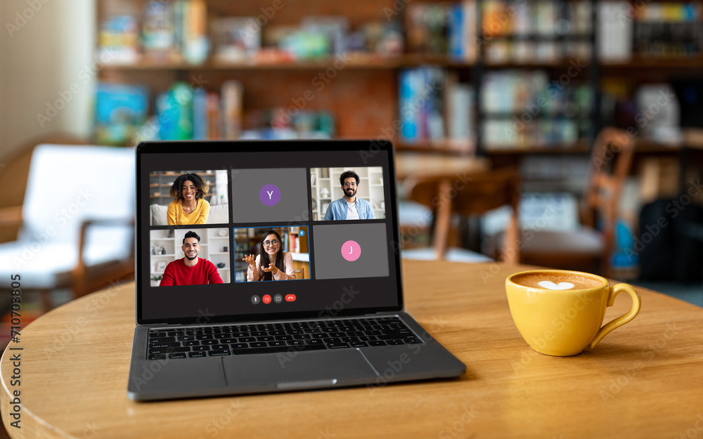 Poster laptop with video call screen on table at cafe