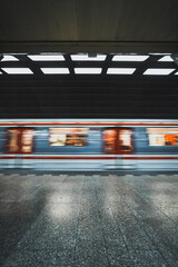 metro train passing station in fast movement
