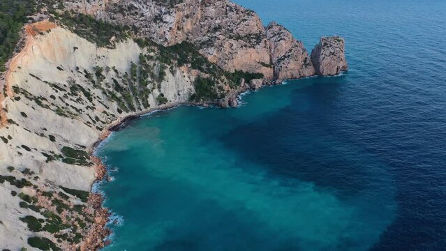 Aerial view of high cliffs and rock formation at Torre des Savinar, Sant Josep de sa Talaia, Ibiza, Balearic Islands, Spain.