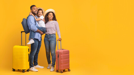 Travel Offer. Beautiful Black Family With Suitcases Looking Aside At Copy Space