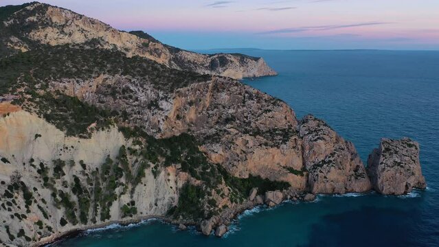 Aerial view of high cliffs and rock formation at Torre des Savinar, Sant Josep de sa Talaia, Ibiza, Balearic Islands, Spain.