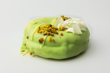 Delicious green pistachio  donut isolated on white background. Dessert, sweet food with nuts