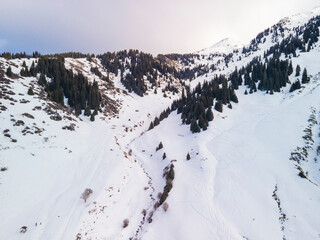 Aerial photography of the Kimasar gorge not far from Almaty in early January. Snowy mountains and gorge in winter.