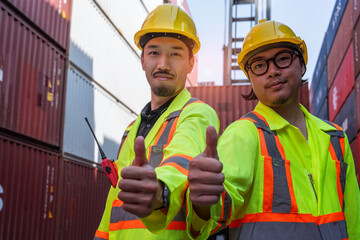 Japanese male engineer and Asian male worker in uniform giving thumbs up, delivery service team,...