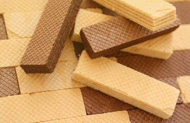 Stacked delicious chocolate wafers in large amount. Two different flavours of classic small waffles
