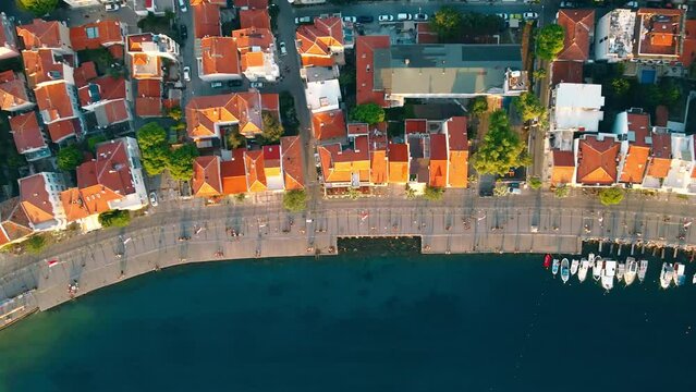 Aerial top down view of promenade in downtown with red rooftops and residential district Foca, near Izmir, Turkiye