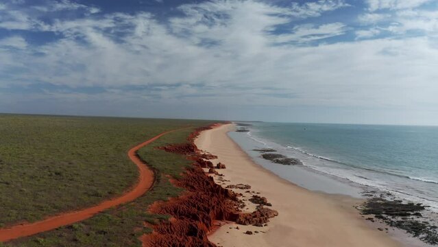 Aerial view of a long coastline with red rock formation and beach at James Price Point Broome, Western Australia, Australia.