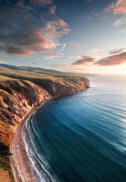 Aerial view of the Fleurieu Peninsula Sellicks Beach coastline from high above the beach with soft sunset clouds in the background. Fleurieu Peninsula, South Australia, Australia.