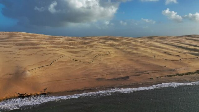 Aerial view of sand dunes along the coastline at Dune of Pilat, France.