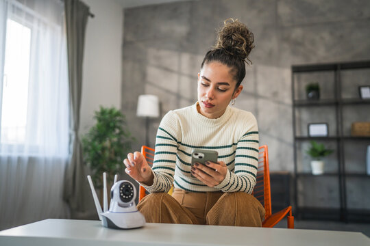 adult caucasian woman set up prepare home surveillance security camera
