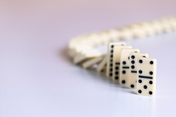 Falling dominoes, domino effect. The bones fall one after the other. The concept of related...