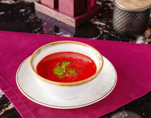 Gazpacho soup with pesto sauce.