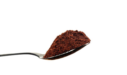 Ground coffee powder in a stainless steel teaspoon isolated on a white background.
