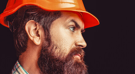 Man builders, industry. Bearded man worker with beard in building helmet or hard hat. Portrait...