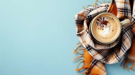 Flat lay composition with coffee and warm plaid on light blue background, space for text     
