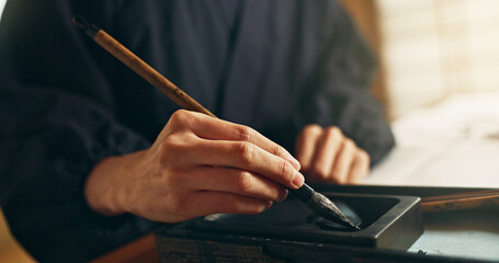 Hands, reed pen or brush in ink for writing, calligraphy or ancient script for art and inkstone....
