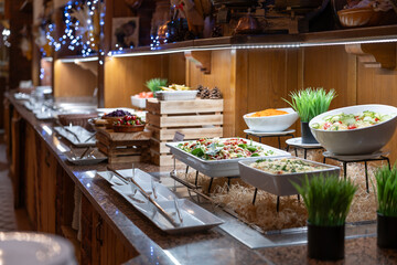 Buffet table full of dishes and salads ready for dinner for hotel guests
