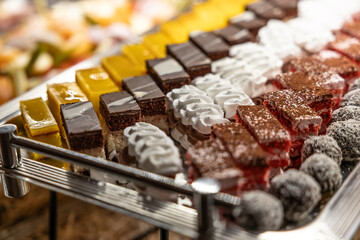 Sliced fresh homemade cakes on a tray at a wedding reception
