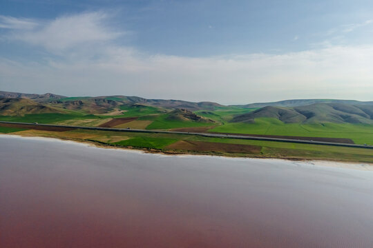 Aerial view of a road driving along the Tuz Golu (Lake Tuz), one of the largest hyper saline lake in the world, Central Anatolia Region, Turkey.