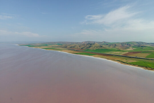 Aerial view of a road driving along the Tuz Golu (Lake Tuz), one of the largest hyper saline lake in the world, Central Anatolia Region, Turkey.