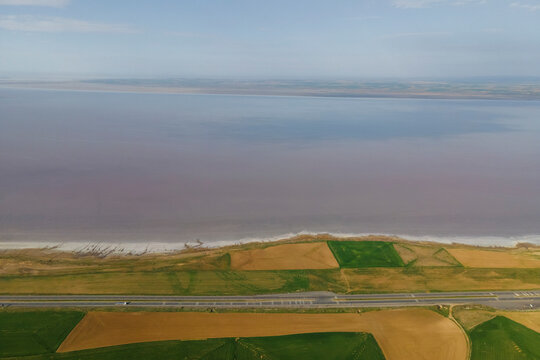 Aerial view of a road driving along the Tuz Golu (Lake Tuz), one of the largest hyper saline lake in the world, Central Anatolia Region, Turkey.