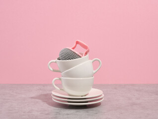 Set of white empty tableware and abrasive sponge. Cleaning dishes.