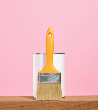 Renovation concept. Paint brush with thick bristles. Metal paint can.