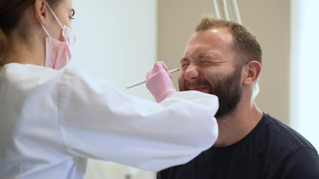 The cosmetologist marks with a pencil the points for beauty injections of botulinum therapy on the face of a man. Concept Plastic surgery and cosmetology for men with copy space