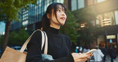 Japanese woman, phone and direction in city with smile, walking or thinking with map by buildings....