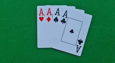 Four of kind cards of aces on green felt casino table background