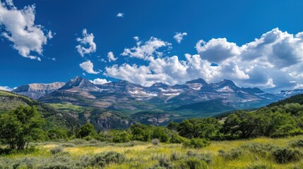 Obraz premium A panoramic view of towering mountains against a brilliant blue sky epitomizes summer beauty