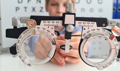 Boy holding trial frame to clinic medical optician concept