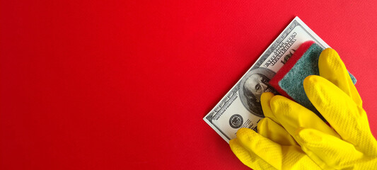 Salary yellow rubber gloves cleaning with hundred dollar bills