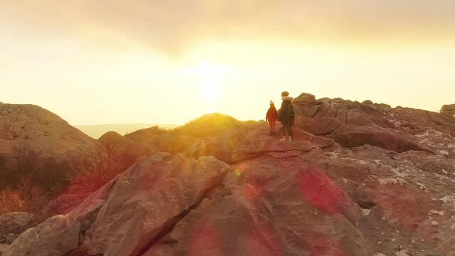 Mom with children in the mountains at sunset Aerial video