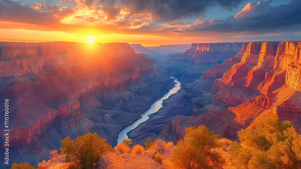 Poster the sun is setting over a canyon with a river in the foreground and trees on the other side of the c