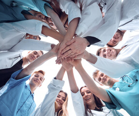 Fototapeta na wymiar bottom view. a group of medical colleagues putting their hands together.