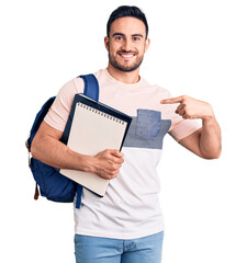 Young handsome man wearing student backpack and notebook pointing finger to one self smiling happy and proud