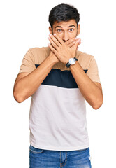 Young handsome man wearing casual clothes shocked covering mouth with hands for mistake. secret concept.